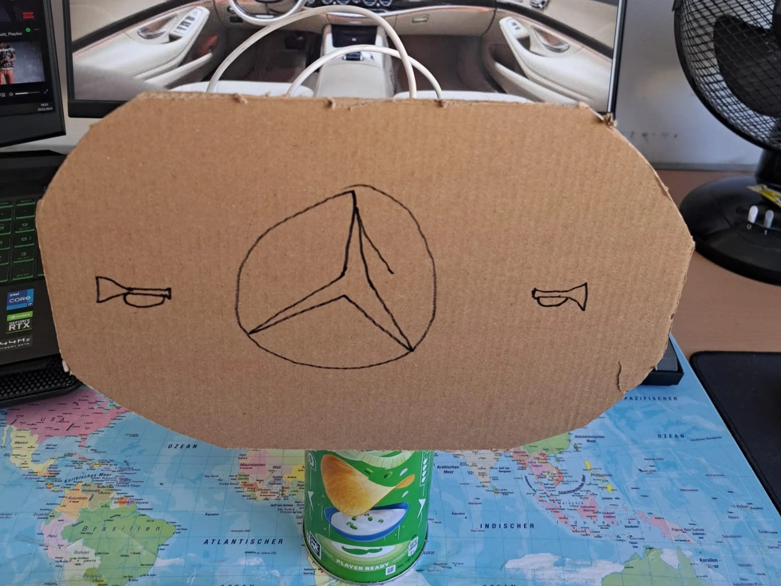 Steering wheel made out of cardboard, on a pringles can
